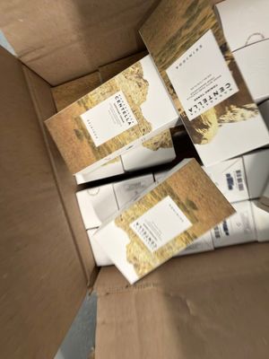 a cardboard box full of boxes of cigarettes and cigarettes