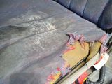 a dirty seat in the back of a car