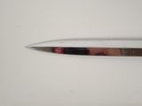 a knife that is laying on a white surface