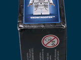 a box with a lego figure in it on a blue background