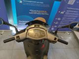 a scooter that is parked in front of a blue sign