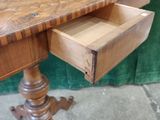 a wooden desk with a drawer on top of it