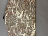 a close up of a piece of marble on a gray surface