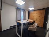 an image of a small office with a desk and chairs