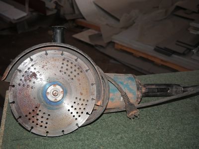 a metal blow dryer sitting on top of a green table