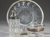 two glass jars and a glass plate on a table