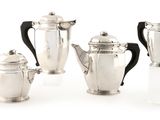 four pieces of silver tea and coffee set on a white background