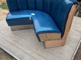 a blue bench made out of cardboard and cardboard boxes