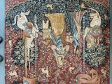 une image représentant une tapisserie accrochée au mur à côté d'une paire de ciseaux