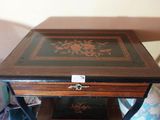 a small wooden table with a drawer on top of it
