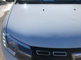 a white car parked in a parking lot with other cars in the background
