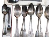 a lot of spoons and forks in a box