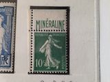 three different colored stamps on a white wall with writing on them