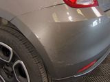 a close up of a car ' s rear end with a tire on it