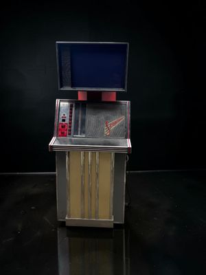 une image représentant un juke-box surmonté d'un téléviseur