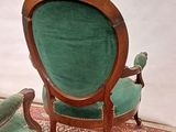 two chairs that are sitting on a rug on the floor
