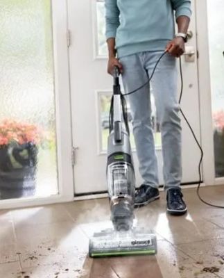 someone is using a vacuum to clean the floor of a house