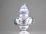 a blue and white vase sitting on a table