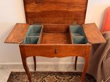 a small wooden table with two drawers on top of it