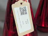 three wine bottles with tags on them sitting on a table