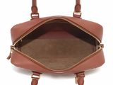 a close up of the inside of a brown handbag on a white background