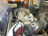 a pile of assorted tires and other items in a box