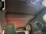 two seats in the back of a car with a steering wheel