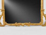 an ornate gold framed mirror on a white background