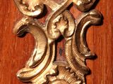 a wooden door with a metal handle and a clock on it