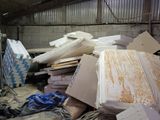 a pile of cardboard and other items in a warehouse