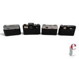 four cameras are lined up next to each other on a white surface