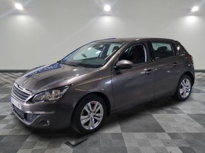 the grey car is parked on a checkered floor in the garage