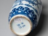 a blue and white vase sitting on a table