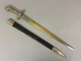 two swords with gold and black handles on a white surface