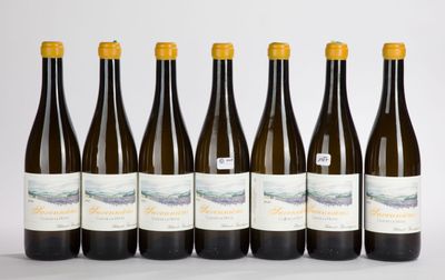 six bottles of wine are lined up in a row