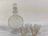 three glasses and a decanter sitting on a table