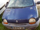 a small blue car that is parked in the grass