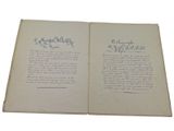 an open book with a handwritten poem on it sitting on top of a table