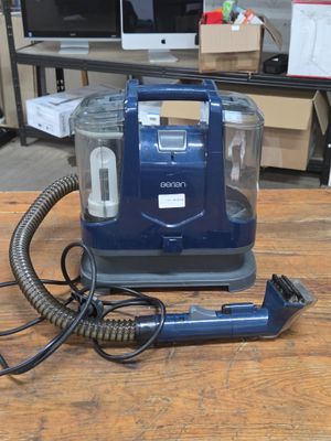 a vacuum that is sitting on a wooden table
