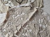 two pieces of cloth with lace on them sitting on a table