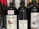 several bottles of wine are lined up on a shelf
