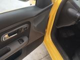 a yellow car with the door open and the door handle open