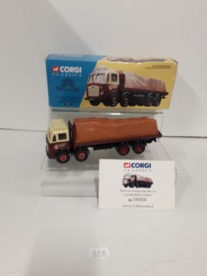 a toy truck and a box on a white surface