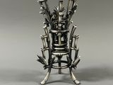a metal chair with a bunch of knives on it