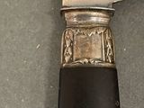 a knife that is sitting on a table next to a knife