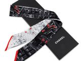 a black and white tie with a red stripe on it
