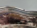 a close up of a silver plate on a table