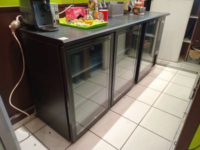 an image of a kitchen with a refrigerator and a counter