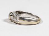 a close up of a diamond ring on a white surface
