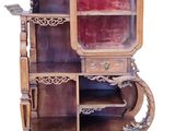 a tall wooden cabinet with a mirror on top of it